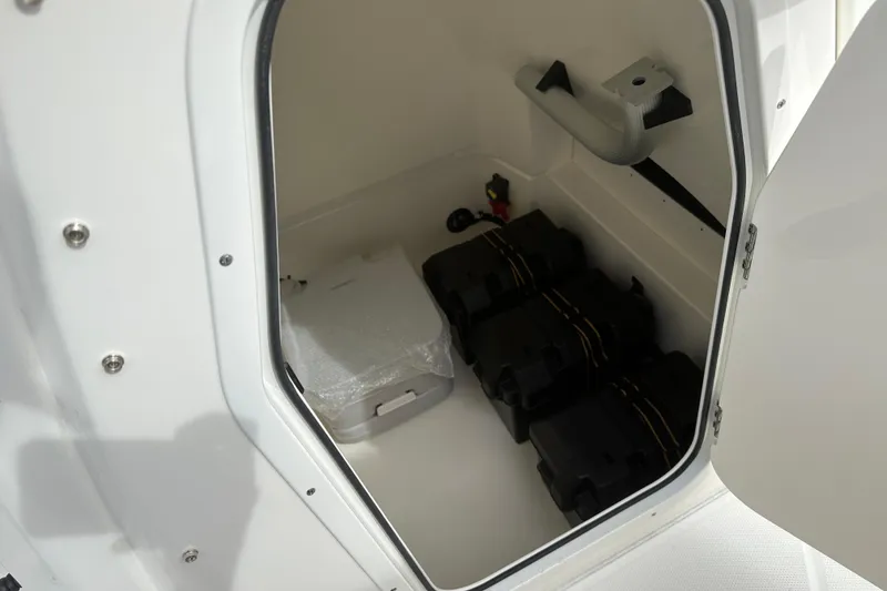 Slide: The Image of Storage compartment of 2026 Boston Whaler 250 Dauntless boat, featuring battery boxes. - 11