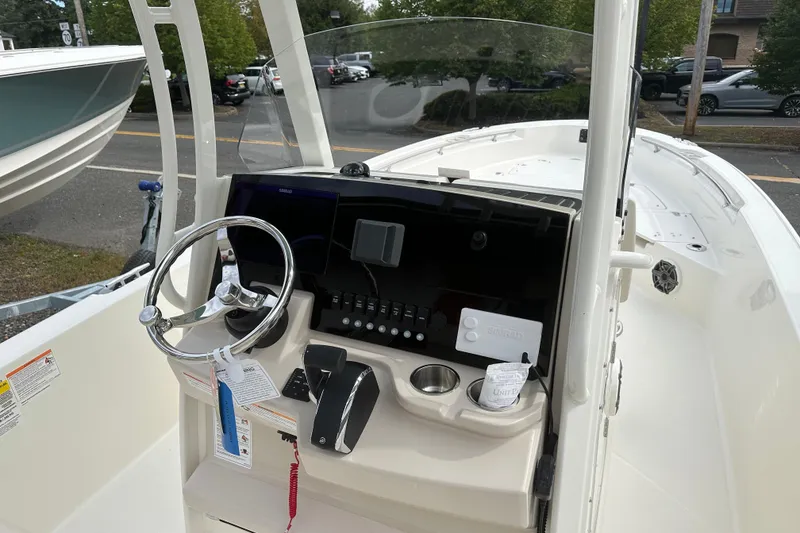 Slide: The Image of 2026 Boston Whaler 250 Dauntless boat console with steering wheel and controls. - 5