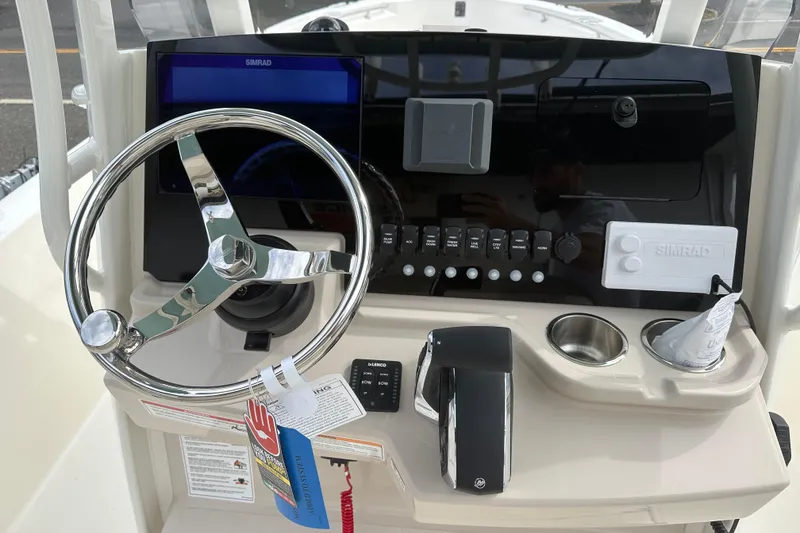 Slide: The Image of 2026 Boston Whaler 250 Dauntless helm with steering wheel and control panel. - 6