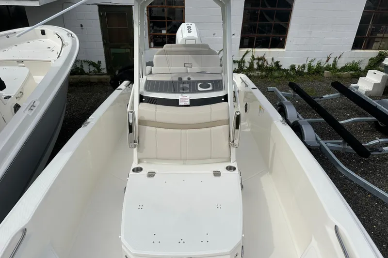 Slide: The Image of 2026 Boston Whaler 250 Dauntless boat, white interior, docked outdoors. - 9