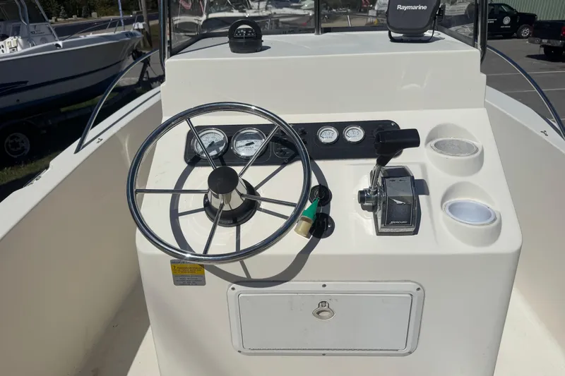 Slide: The Image of 2002 Seahunt Triton 202 boat dashboard with steering wheel and controls. - 10