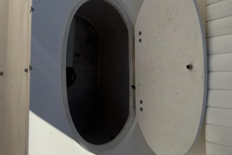 Slide: The Image of Open storage compartment on a 2002 Seahunt Triton 202 boat. - 14