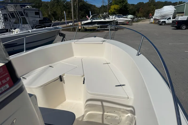 Slide: The Image of 2002 Seahunt Triton 202 boat interior with seating, parked in a marina. - 8