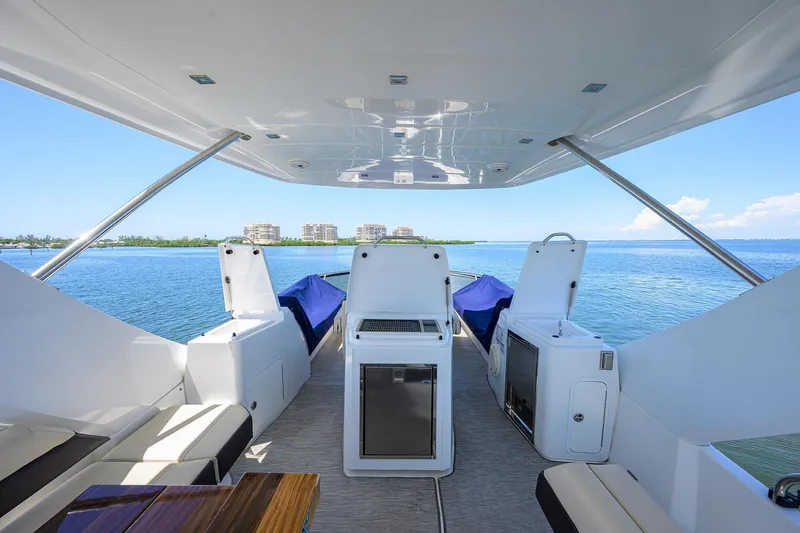 Slide: The Image of 2018 Cruisers 60 Cantius Fly yacht interior with ocean view, featuring modern seating and amenities. - 20