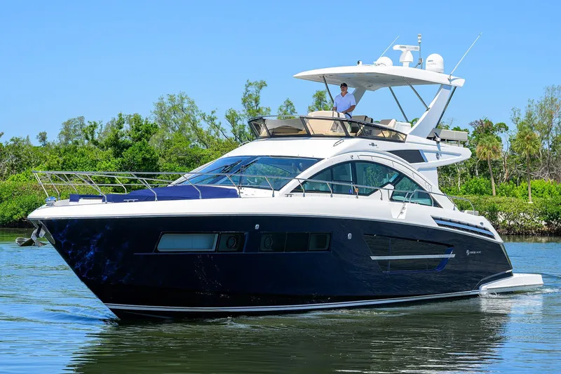 Slide: The Image of 2018 Cruisers 60 Cantius Fly yacht cruising on a serene waterway. - 3
