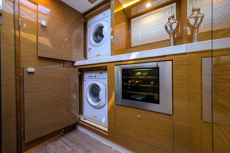 Slide: The Image of Laundry and wine storage area on 2018 Cruisers 60 Cantius Fly yacht. - 47