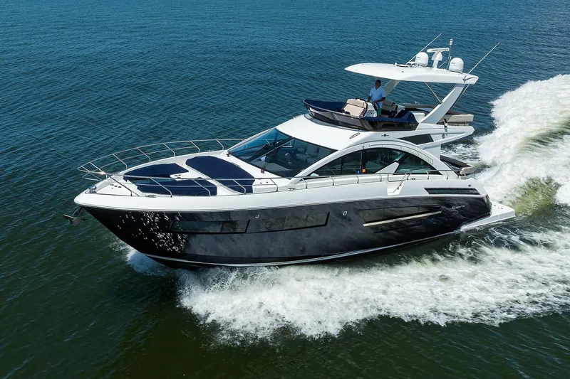 Slide: The Image of 2018 Cruisers 60 Cantius Fly yacht cruising on open water. - 7