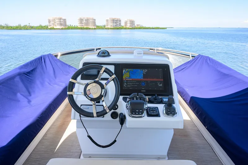 Slide: The Image of 2018 Cruisers 60 Cantius Fly yacht helm with navigation display and steering wheel. - 18