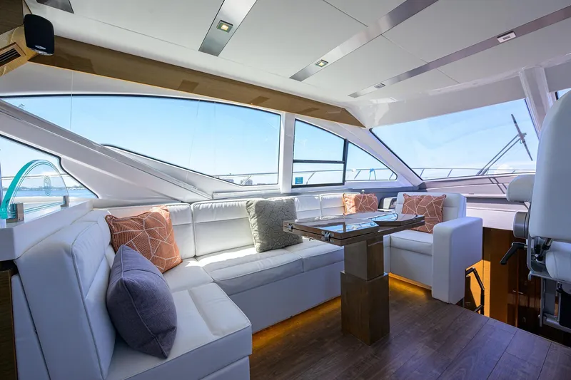 Slide: The Image of Luxurious interior of 2018 Cruisers 60 Cantius Fly yacht with elegant seating and panoramic windows. - 27