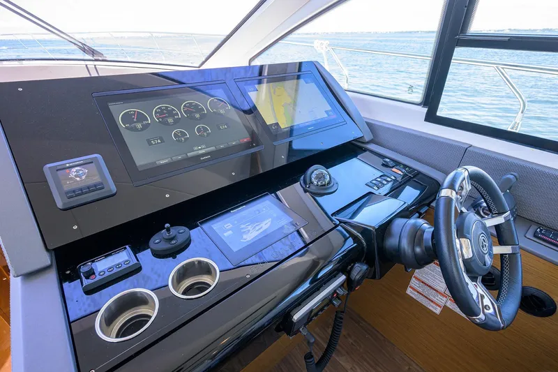 Slide: The Image of Helm of 2018 Cruisers 60 Cantius Fly yacht with advanced navigation displays. - 35