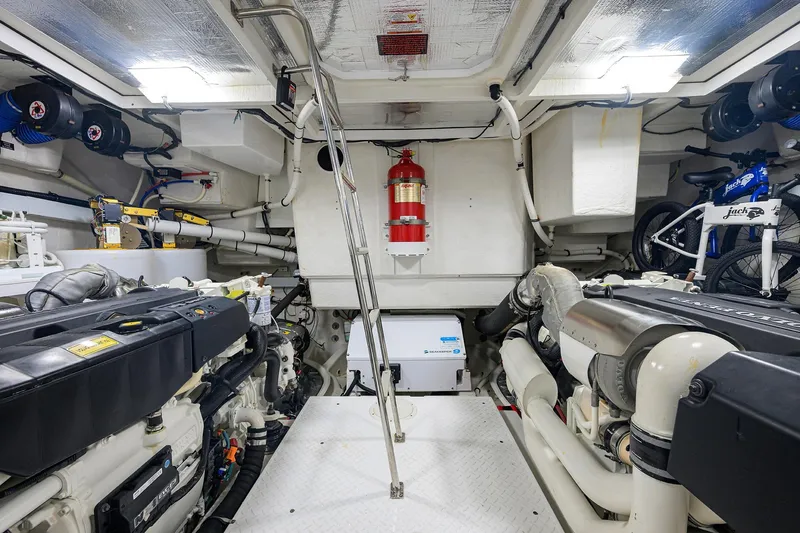 Slide: The Image of Engine room of 2018 Cruisers 60 Cantius Fly yacht, featuring dual engines and equipment. - 61