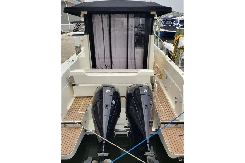 Slide: The Image of 2024 Bayliner Trophy T29 Explorer with dual outboard engines, docked at marina. - 11