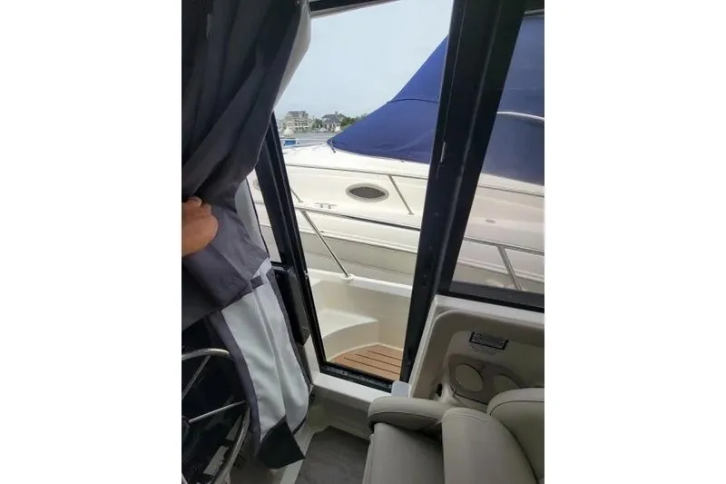 Slide: The Image of Interior view of 2024 Bayliner Trophy T29 Explorer, showcasing door and seating area. - 9