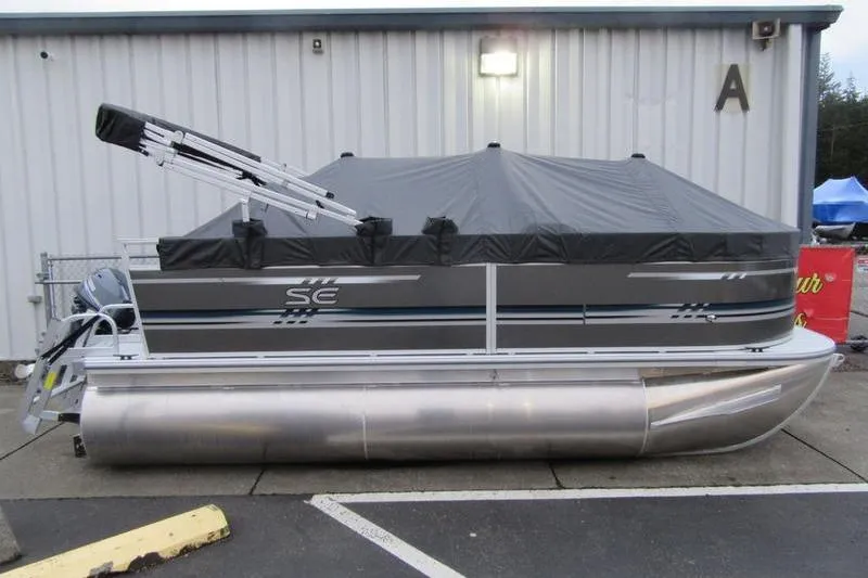 The Image of 2025 South Bay 16 FC SE pontoon boat with cover, parked outdoors. - 0