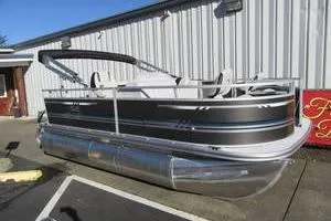 Slide: The Image of 2025 South Bay 16 FC SE pontoon boat parked outside a building. - 1
