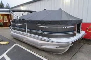 Slide: The Image of 2025 South Bay 16 FC SE pontoon boat with cover, parked outdoors. - 11