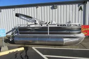 Slide: The Image of 2025 South Bay 16 FC SE pontoon boat parked outside a metal building. - 7