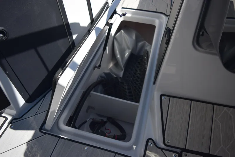 Slide: The Image of 2024 Yamaha Boats 222XD storage compartment with open hatch. - 16