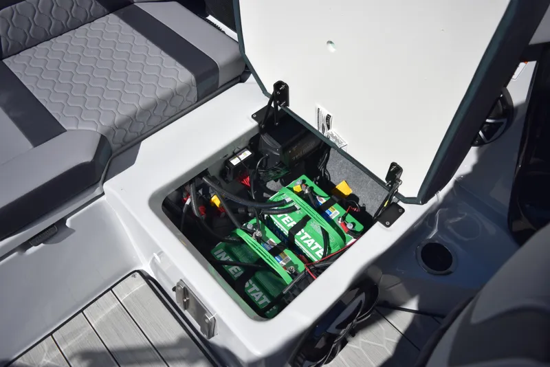 Slide: The Image of 2024 Yamaha Boats 222XD battery compartment with open hatch. - 17