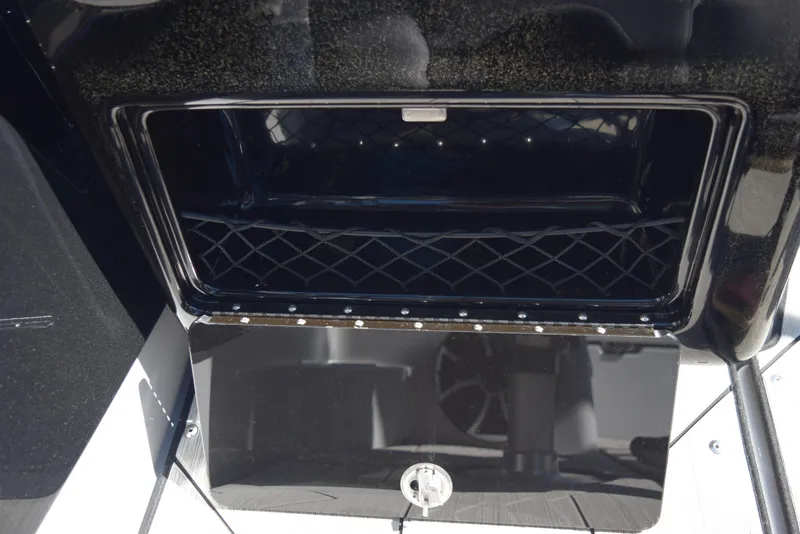 Slide: The Image of Open storage compartment on a 2024 Yamaha Boats 222XD. - 23
