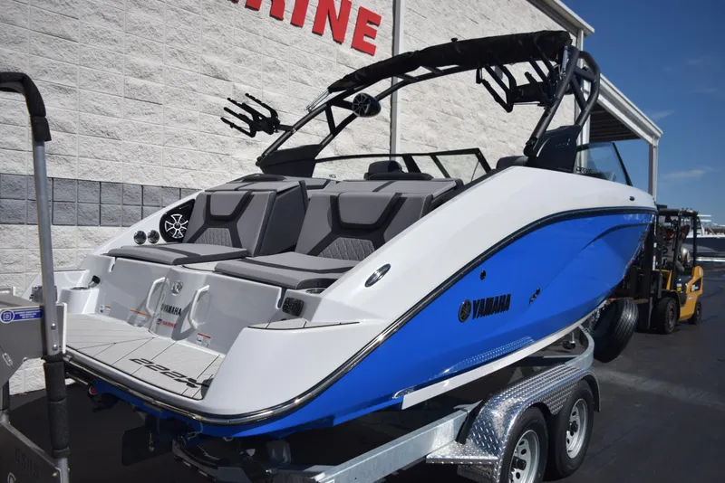 Slide: The Image of 2024 Yamaha Boats 222XD on trailer, rear view, blue and white hull. - 3