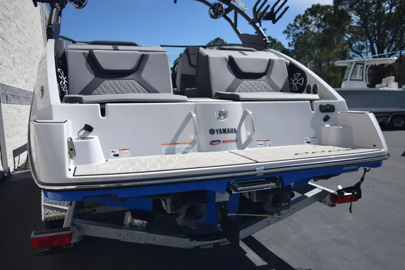 Slide: The Image of 2024 Yamaha Boats 222XD rear view, showcasing seating and swim platform. - 5