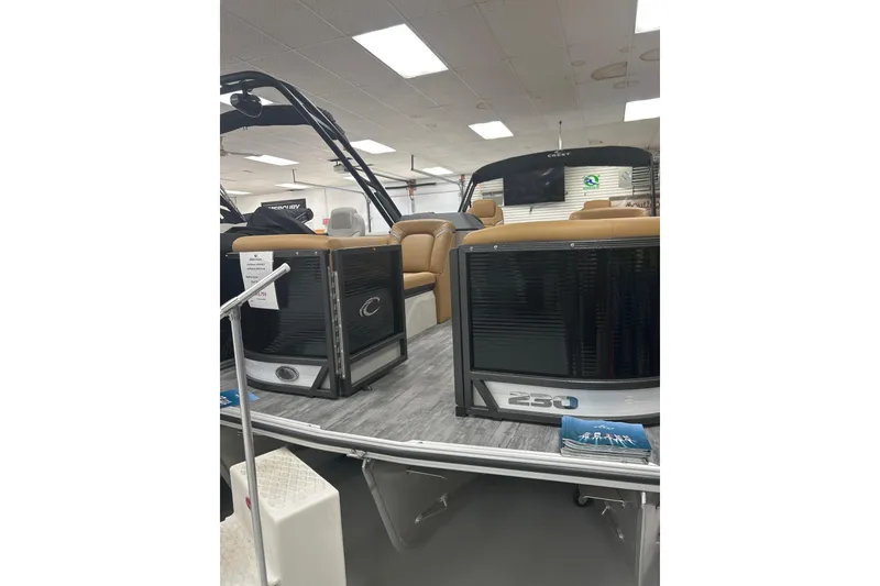 The Image of 2024 Crest Caribbean LX 230 SLS pontoon boat displayed indoors with seating and modern design. - 0