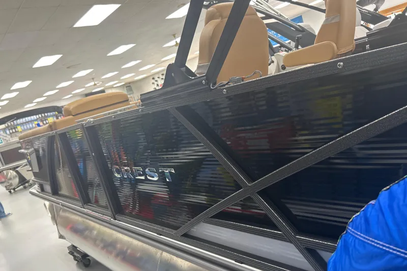 Slide: The Image of 2024 Crest Caribbean LX 230 SLS boat displayed indoors, featuring sleek design and comfortable seating. - 2