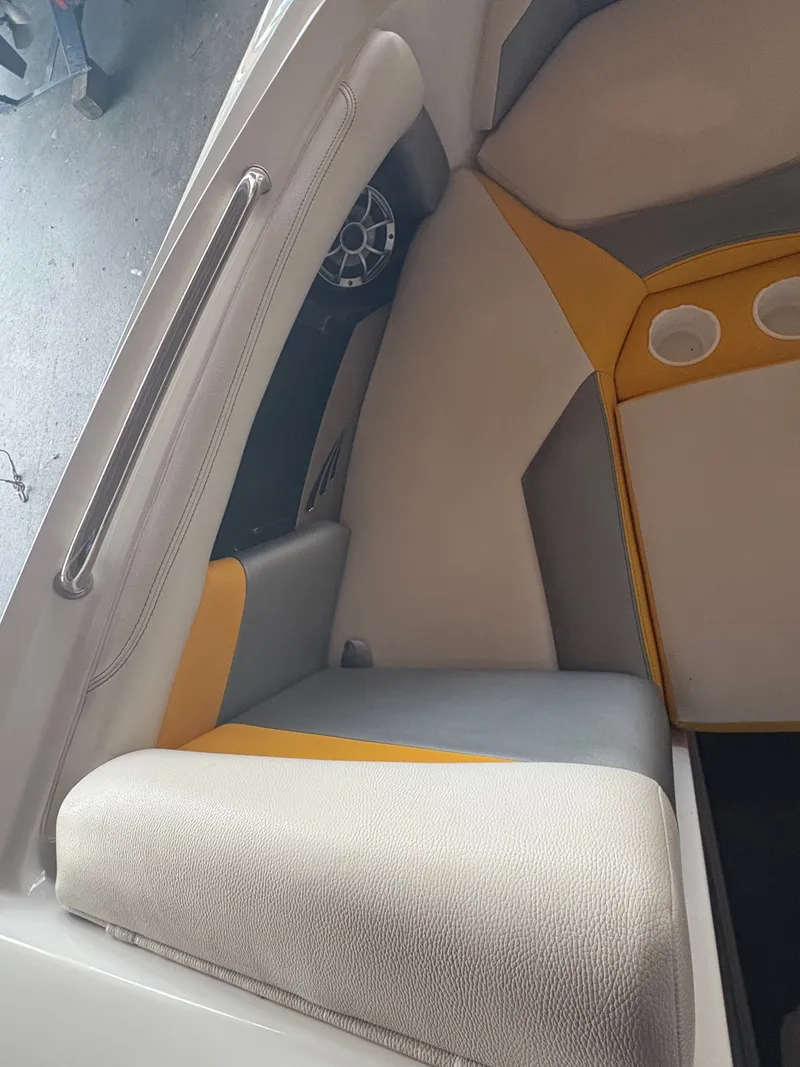 Slide: The Image of 2014 Tigé R20 boat interior with gray and yellow seating. - 14
