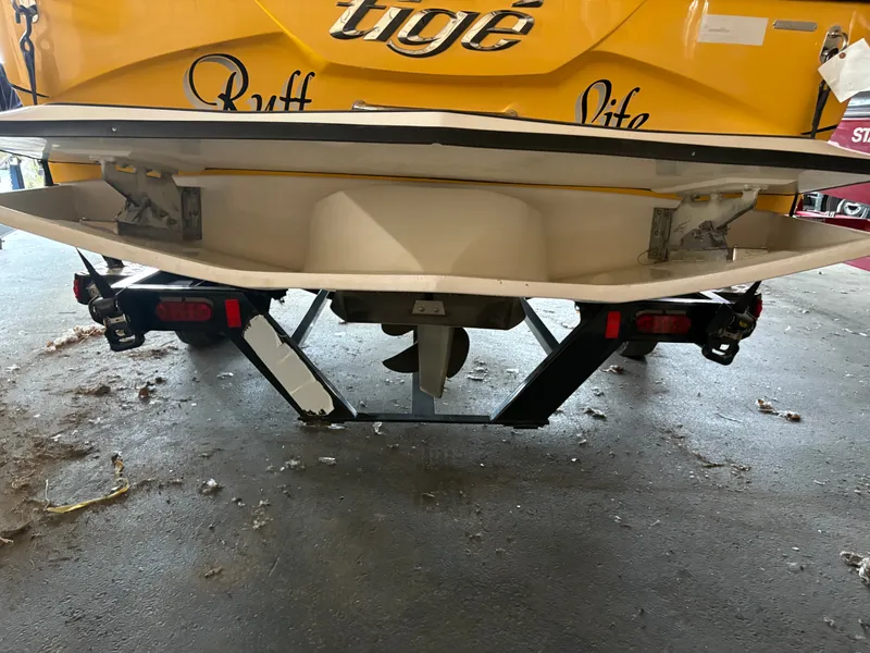 Slide: The Image of Rear view of a 2014 Tigé R20 boat on a trailer in a garage. - 18