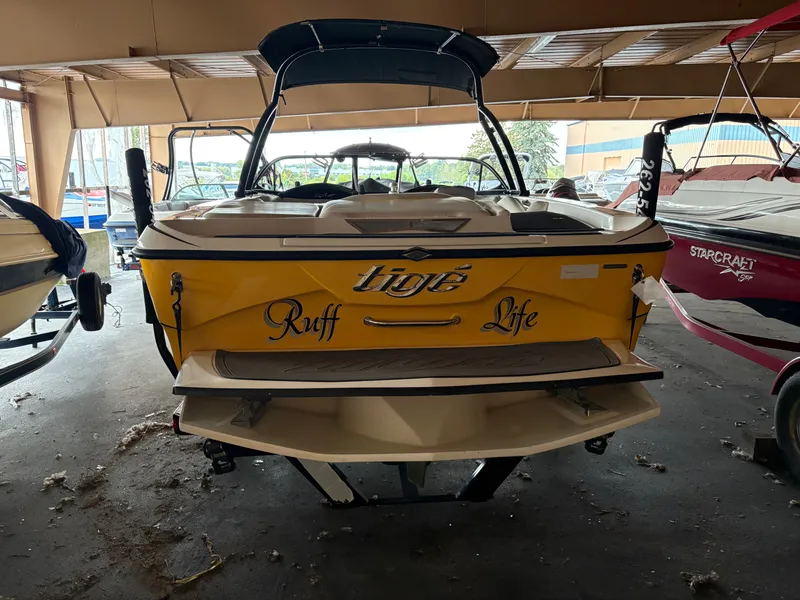 Slide: The Image of 2014 Tigé R20 boat with "Ruff Life" text, parked indoors. - 3