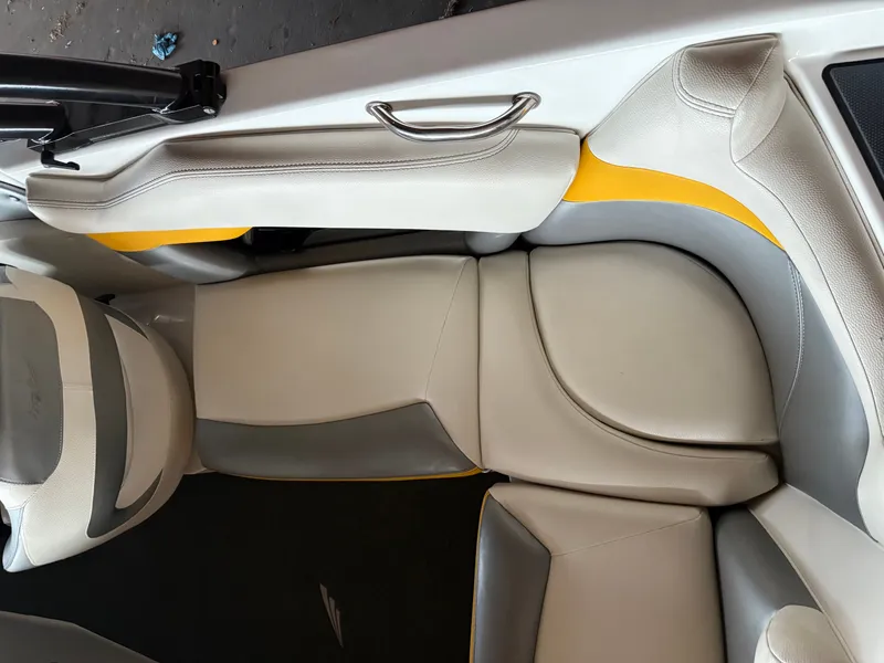 Slide: The Image of 2014 Tigé R20 boat interior with gray and yellow seating. - 6