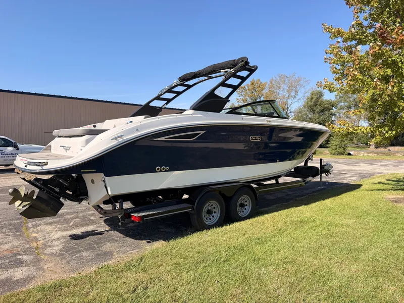 Slide: The Image of A 2026 Sea Ray SDX 270 boat on a trailer, parked on grass. - 5