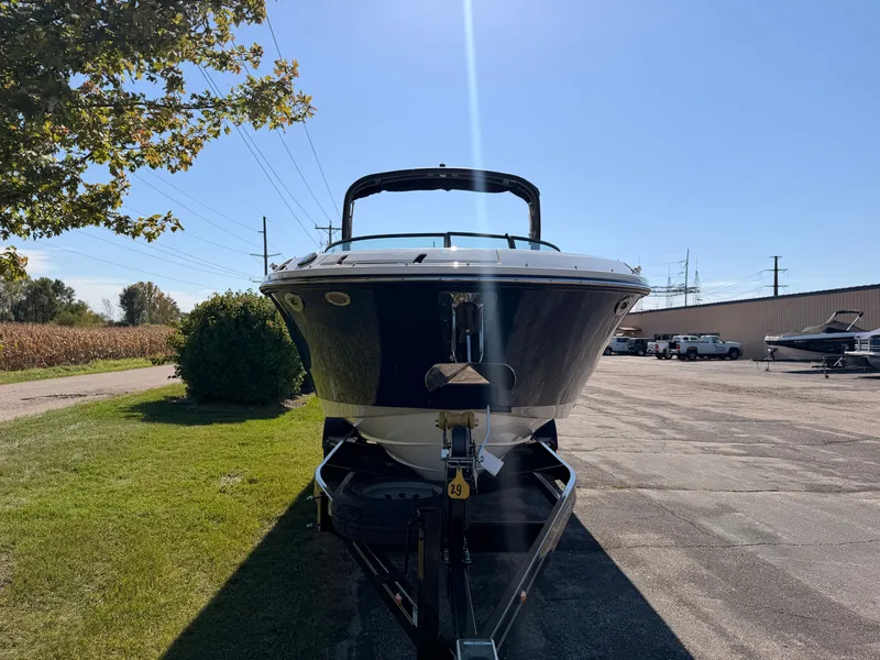 Slide: The Image of A 2026 Sea Ray SDX 270 boat is on a trailer in a parking area. - 8
