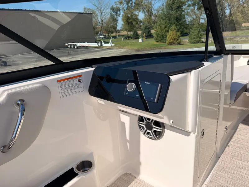 Slide: The Image of The image shows the cockpit of a 2026 Sea Ray SDX 270 with modern controls. - 34