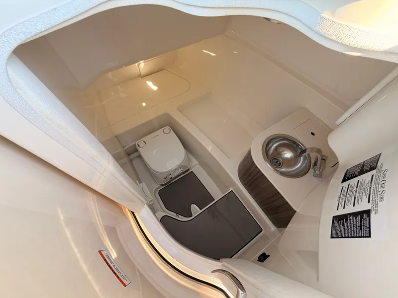 Slide: The Image of Interior view of a 2026 Sea Ray SDX 270 featuring a toilet and sink. - 52