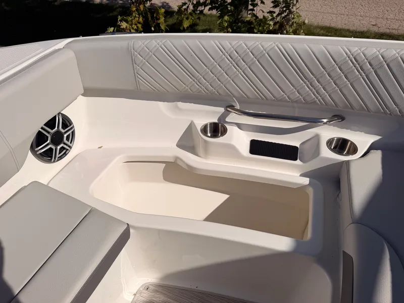 Slide: The Image of The image shows the seating area of a Sea Ray SDX 270 boat with speaker and cup holders. - 64