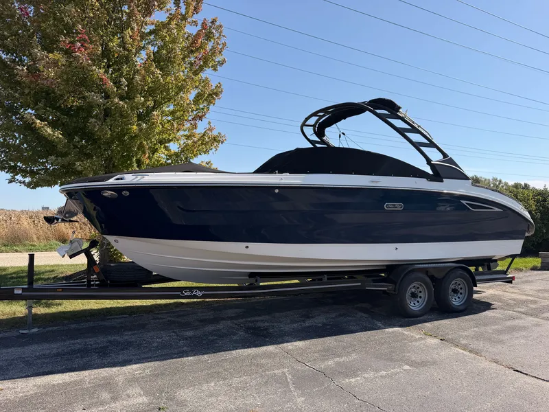 Slide: The Image of 2026 Sea Ray SDX 270 on a trailer, featuring a blue hull and black wakeboard tower. - 1