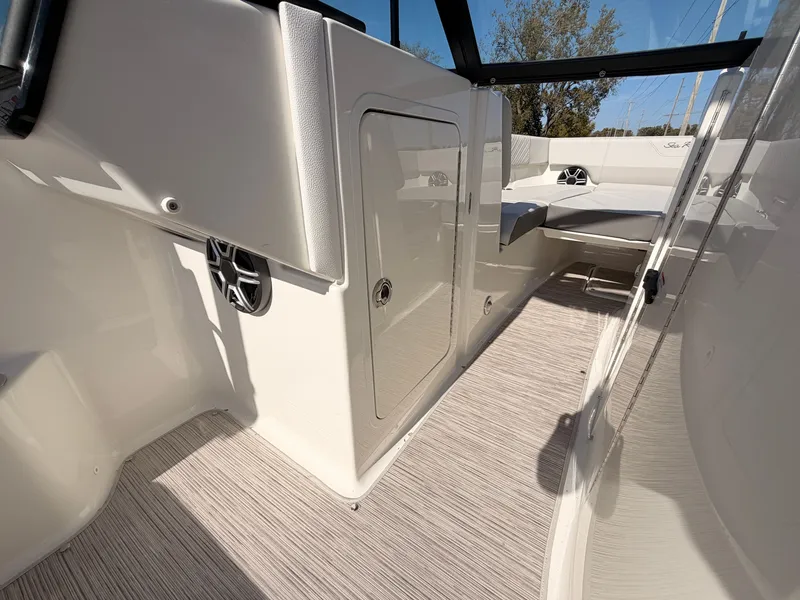 Slide: The Image of Interior of a Sea Ray SDX 270 boat with sleek seating and modern speakers. - 53