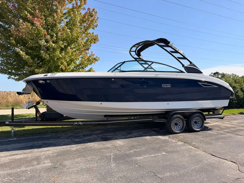The Image of A 2026 Sea Ray SDX 270 on a trailer, featuring a blue hull and sleek design. - 0