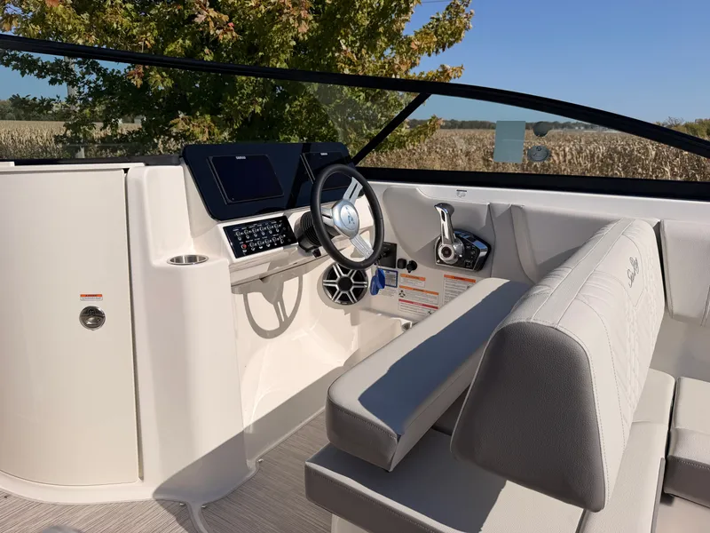 Slide: The Image of The image shows the cockpit of a Sea Ray SDX 270 boat with a modern helm. - 36