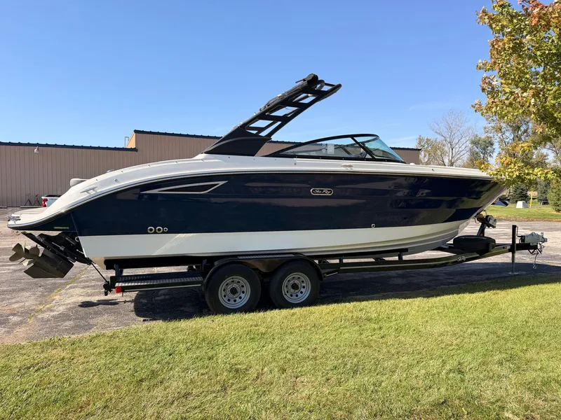Slide: The Image of 2026 Sea Ray SDX 270 on a trailer, featuring a blue hull and black canopy. - 7