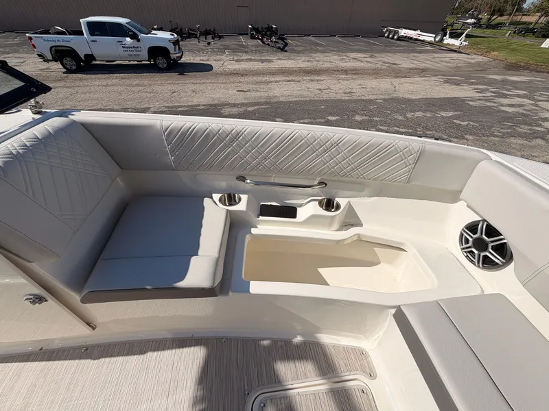 Slide: The Image of The image shows the seating area of a Sea Ray SDX 270 boat with cushioned seats and speakers. - 60