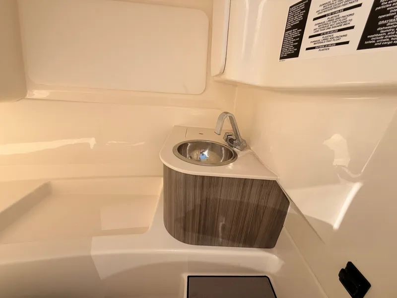 Slide: The Image of The image shows a sleek sink in a modern boat bathroom with wood paneling. - 50