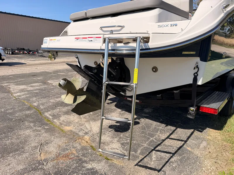 Slide: The Image of A 2026 Sea Ray SDX 270 with a retractable swim ladder at the stern. - 16