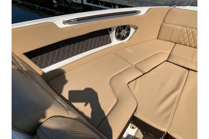 Slide: The Image of 2023 Sea Ray SLX 280 interior with tan leather seating and speaker detail. - 11