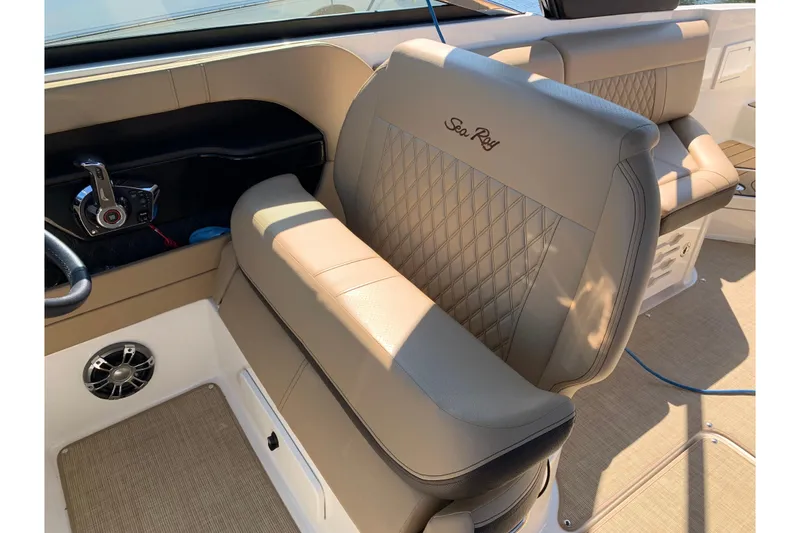 Slide: The Image of 2023 Sea Ray SLX 280 interior with luxurious beige seating and modern controls. - 12