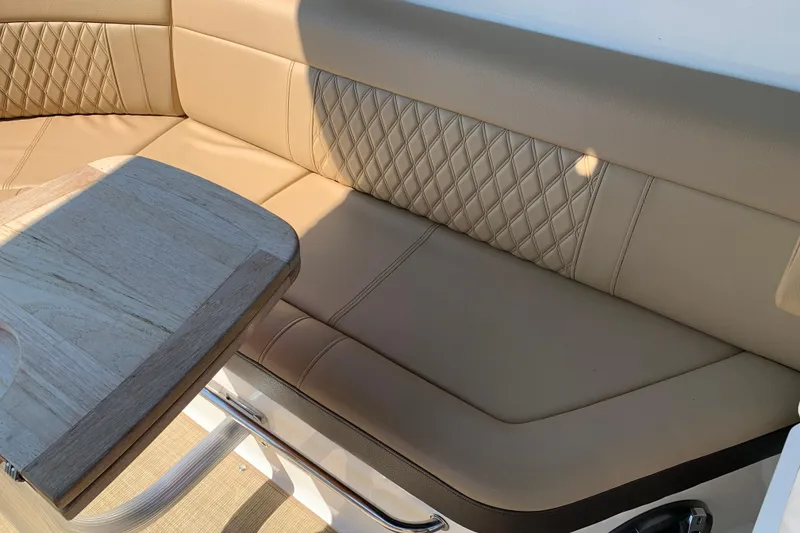 Slide: The Image of Luxurious seating and table on 2023 Sea Ray SLX 280 boat, featuring elegant design and comfort. - 16