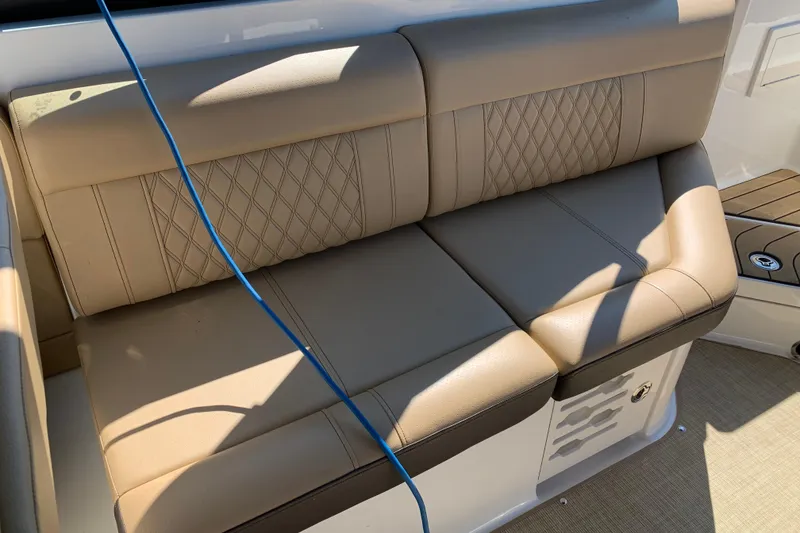 Slide: The Image of Luxurious tan seating on 2023 Sea Ray SLX 280 boat, featuring diamond stitching. - 17