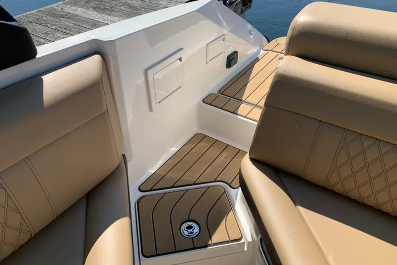 Slide: The Image of 2023 Sea Ray SLX 280 boat interior with tan leather seats and wood accents. - 19
